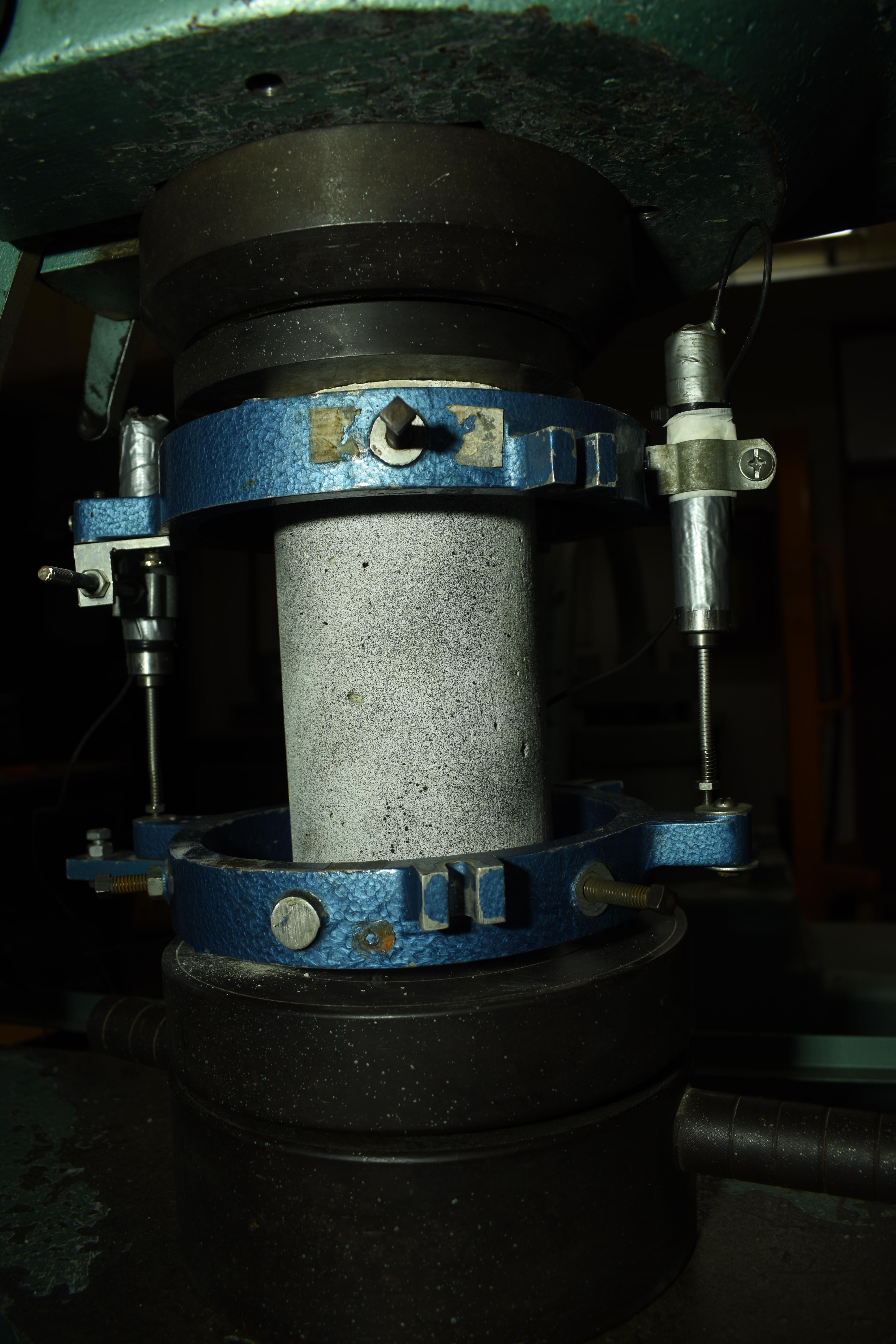 Concrete cylinder in compression machine