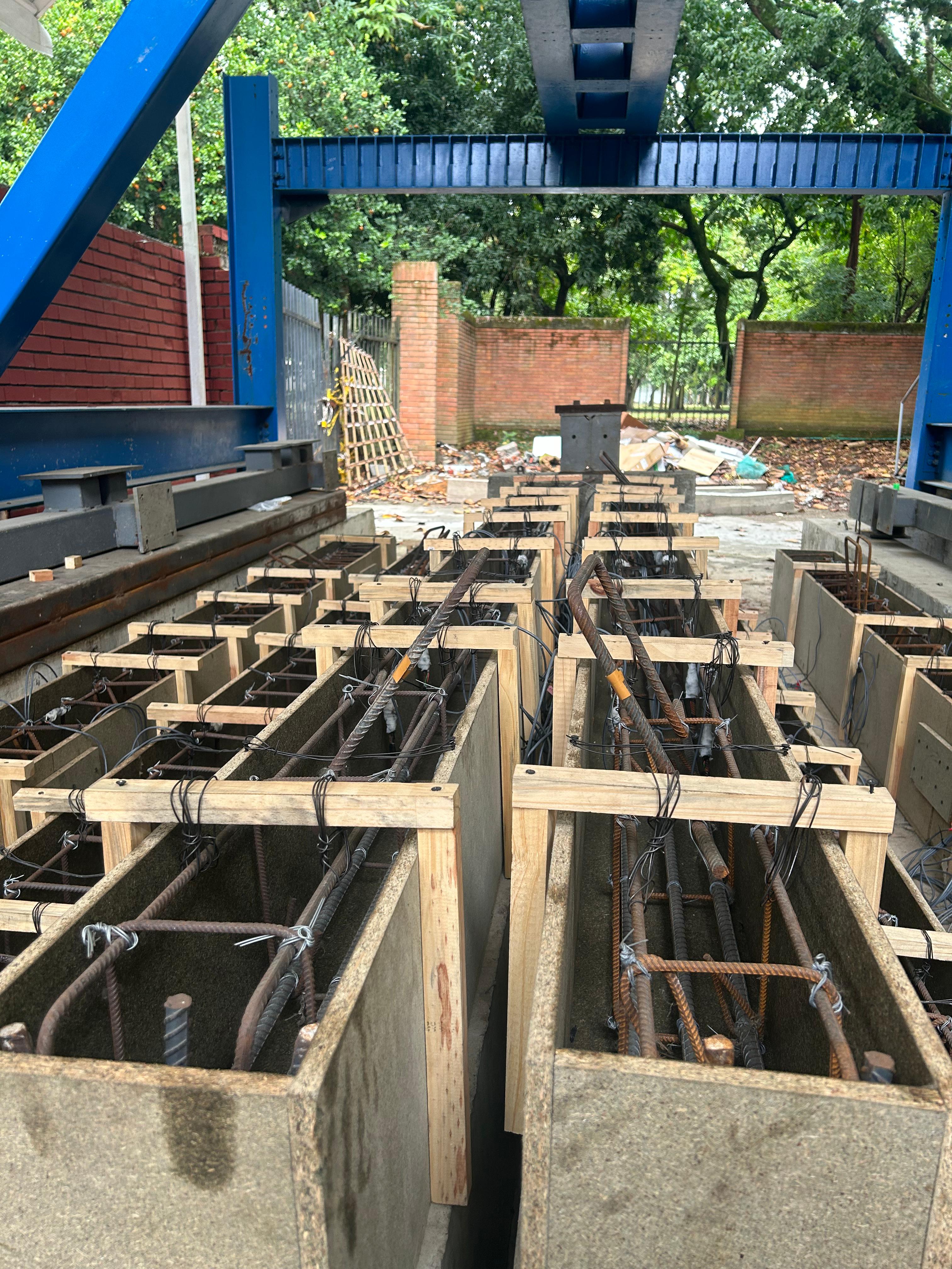 Concrete beam molds being prepared
