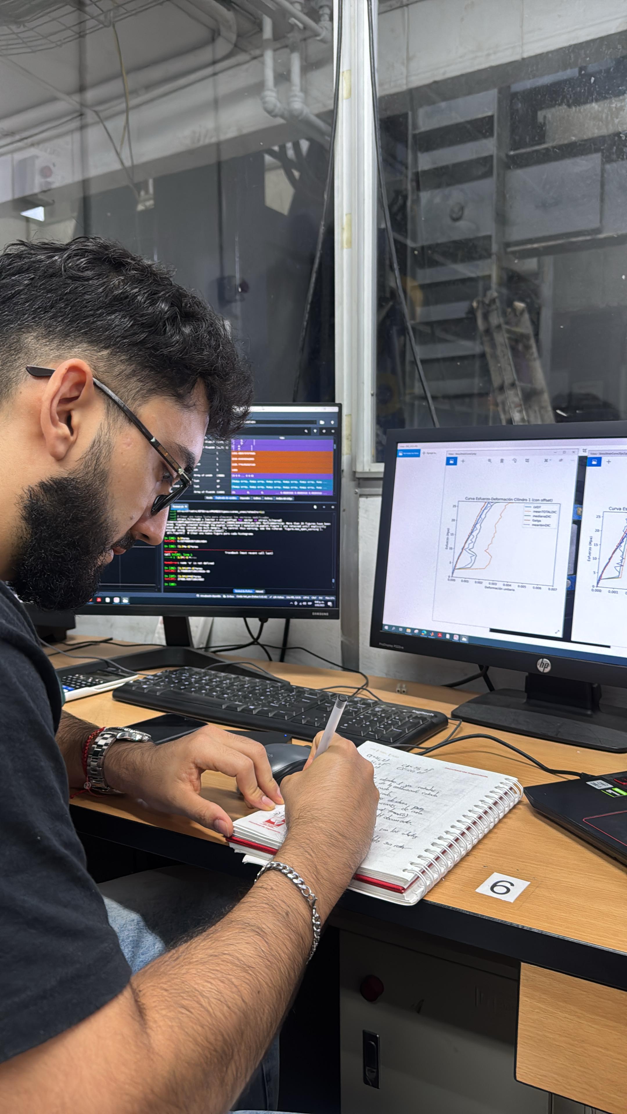 Juan Manuel analyzing data at workstation